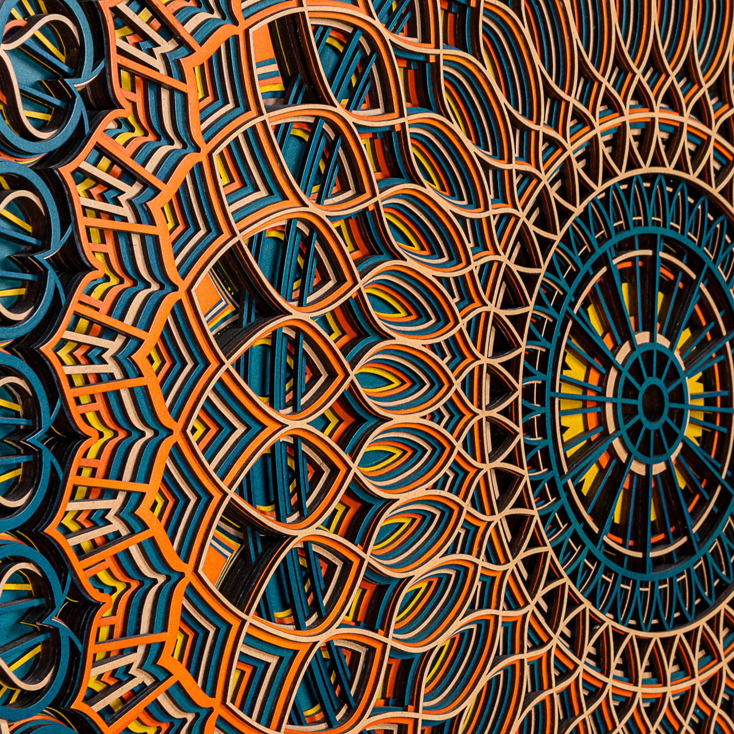 Detailed layered geometric patterns on wooden mandala art