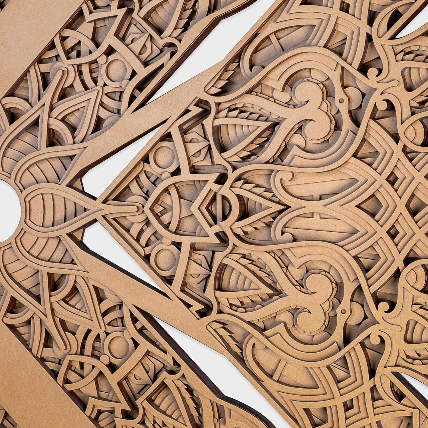 Intricate ornamental cutwork and geometric patterns on wooden wall art