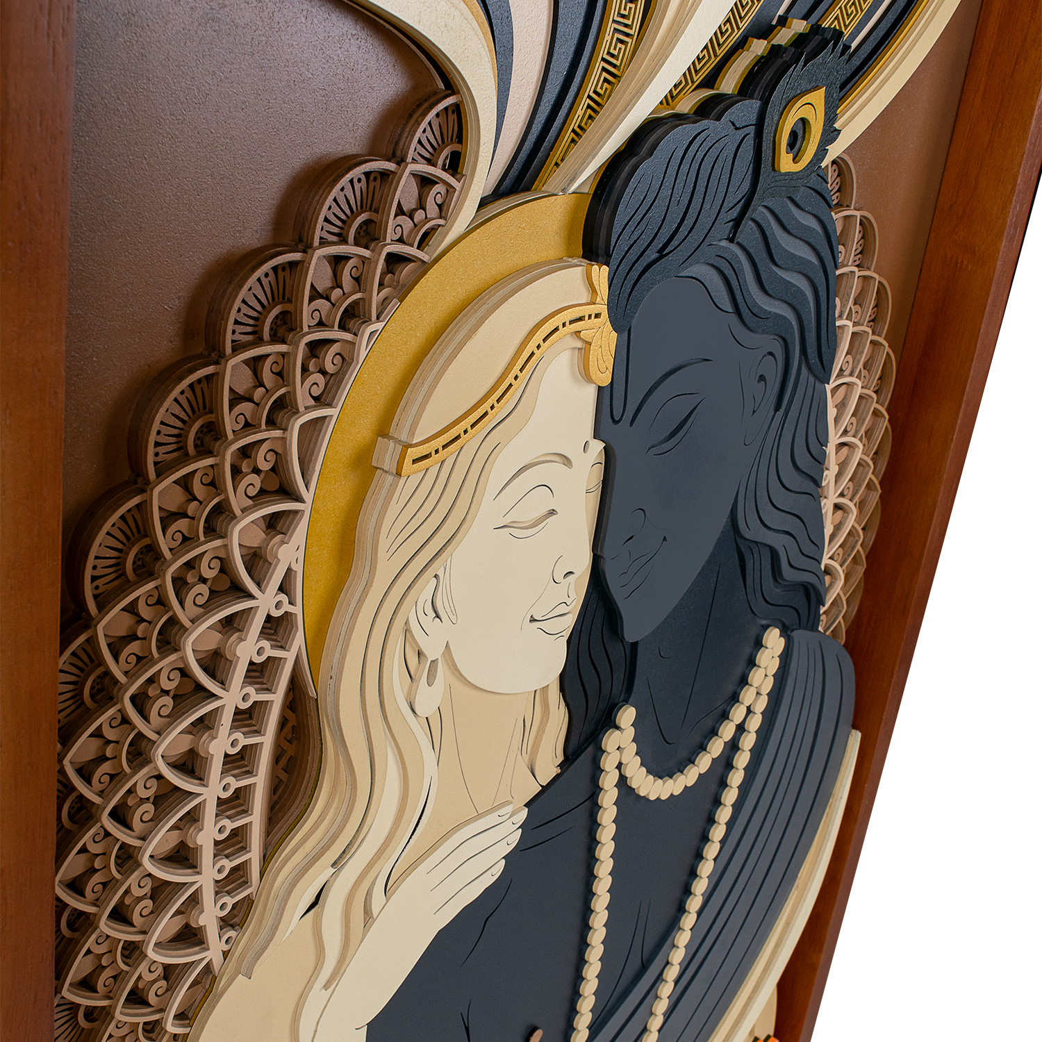 Close-up of Radha and Krishna figures in detailed multi-layered wall art